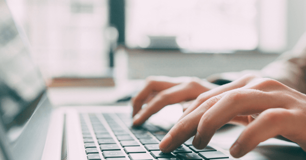 Hands on laptop keyboard