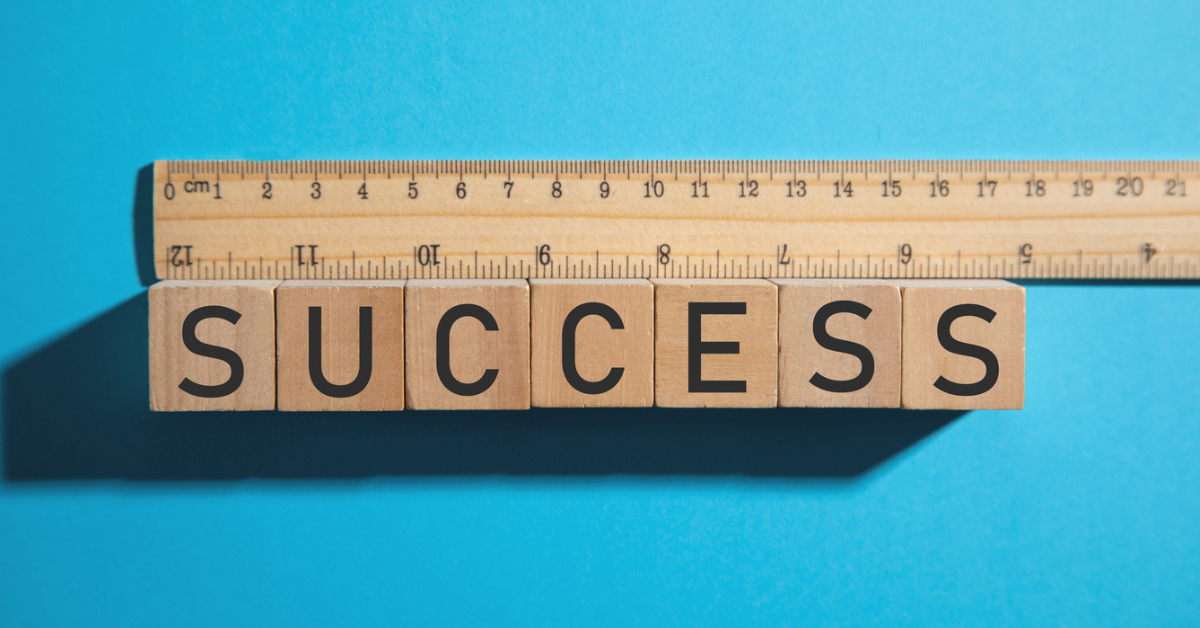 Measuring Success. Ruler with Success text on wooden cube