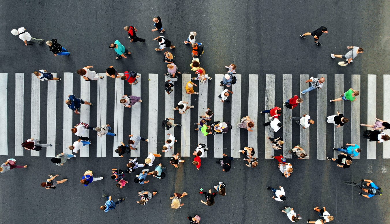 Returning to the Office - Aerial shot of people walking across the pedestrian crossing. 